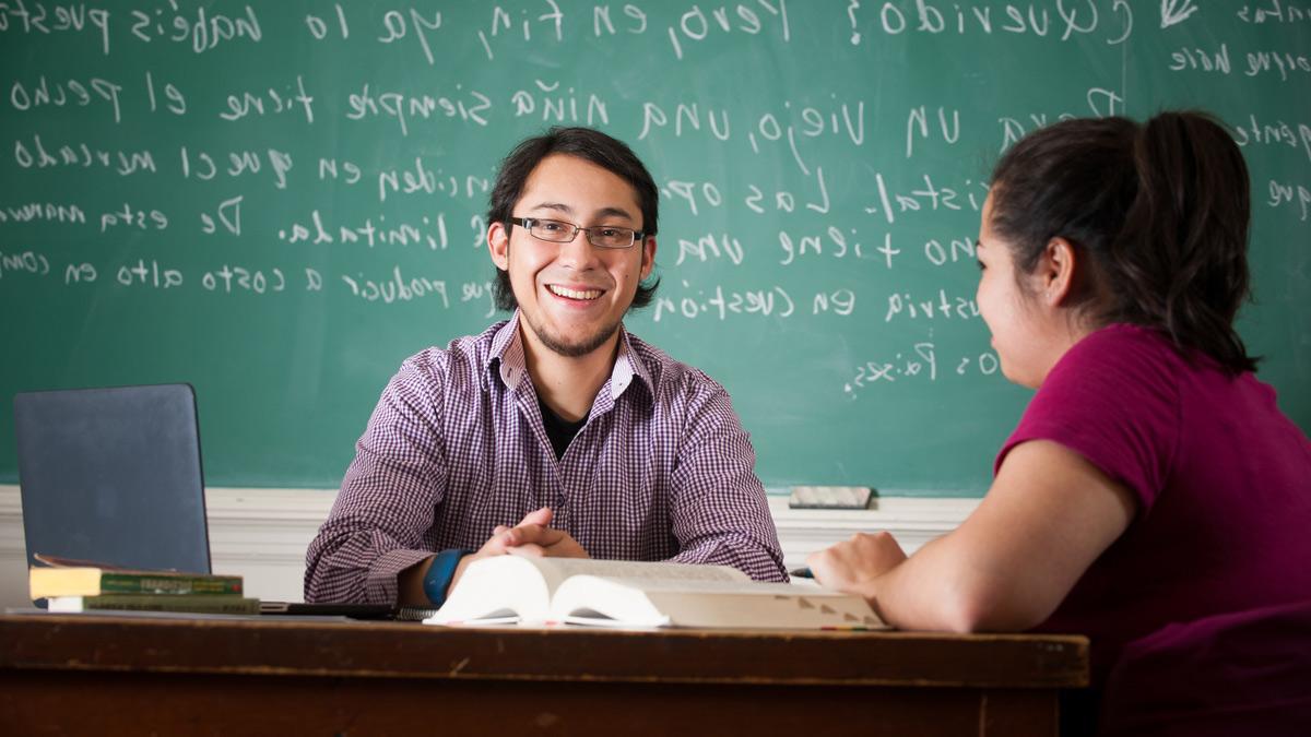 Two students studying Spanish texts.